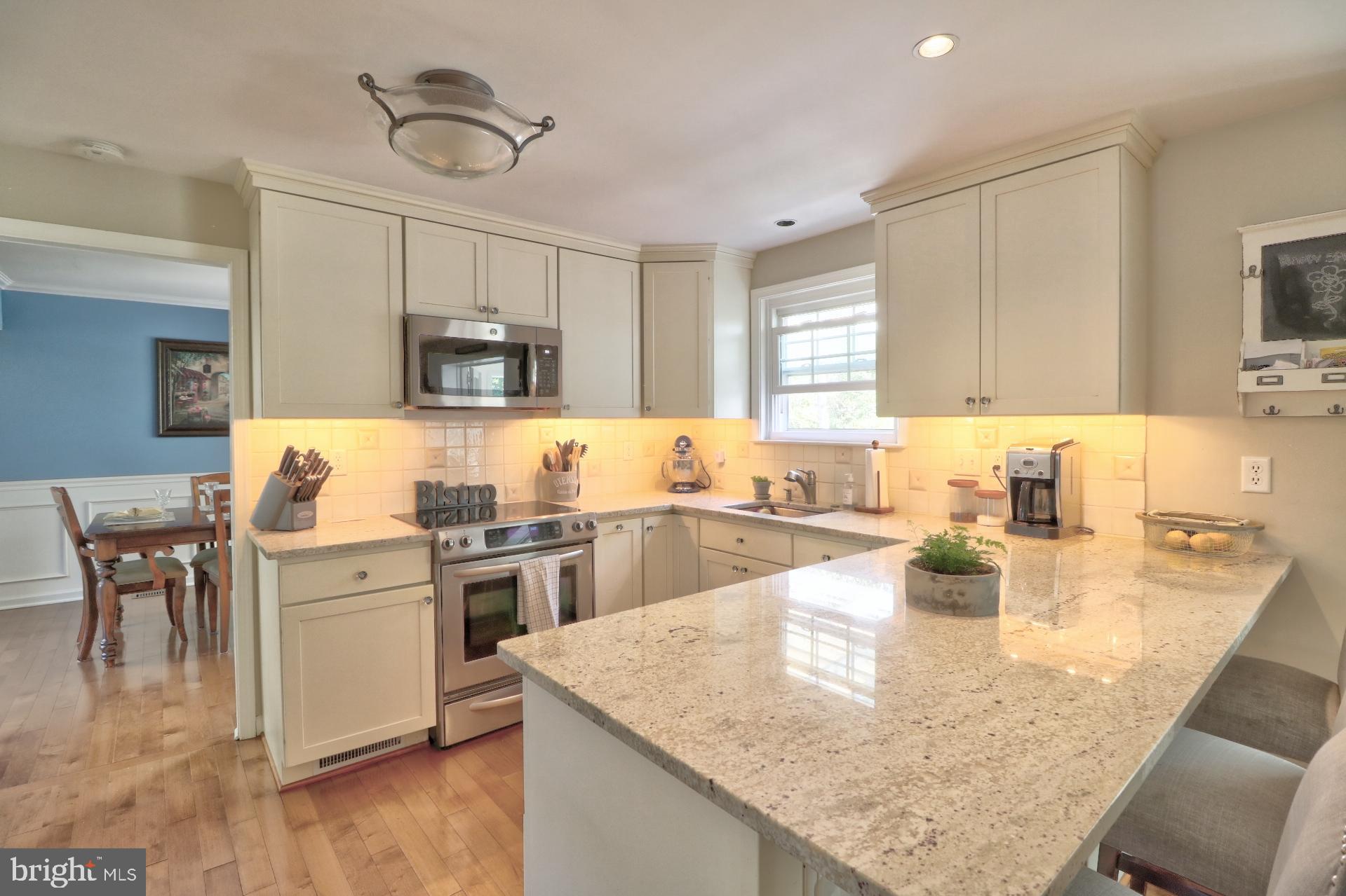 4701 Vicky Road Baltimore, MD 21236 - Photo 14 of 39 a kitchen with kitchen island a sink stove and refrigerator