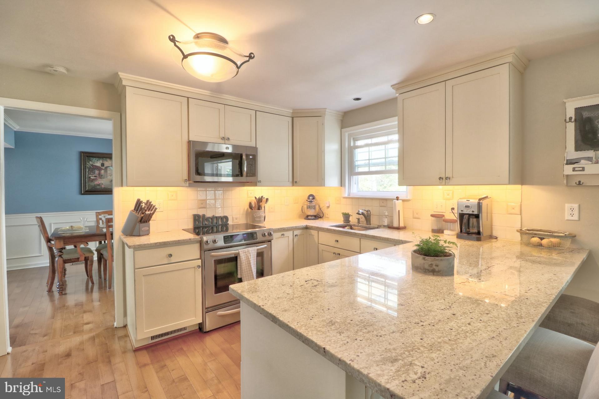4701 Vicky Road Baltimore, MD 21236 - Photo 15 of 39 a kitchen with kitchen island a sink stove and refrigerator