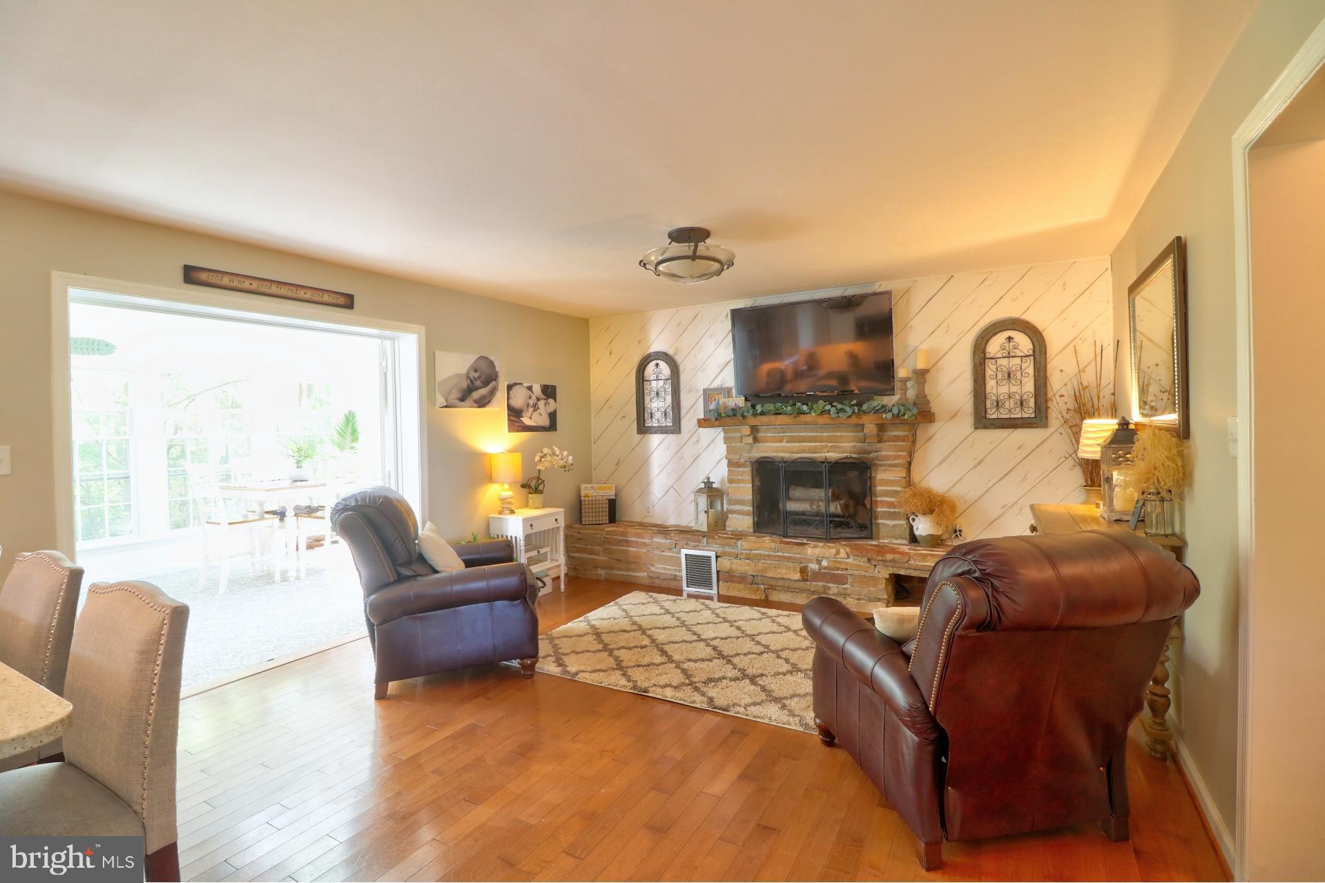 4701 Vicky Road Baltimore, MD 21236 - Photo 17 of 39 a living room with fireplace furniture and a large window