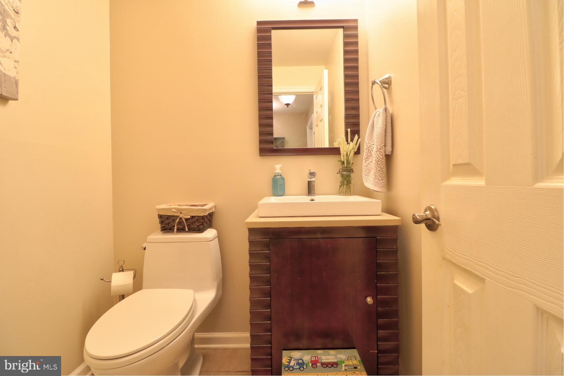 4701 Vicky Road Baltimore, MD 21236 - Photo 25 of 39 a bathroom with a toilet a sink and mirror