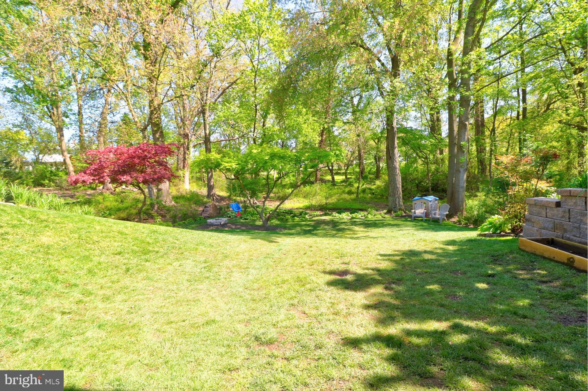 4701 Vicky Road Baltimore, MD 21236 - Photo 35 of 39 a backyard of a house with lots of green space and fountain