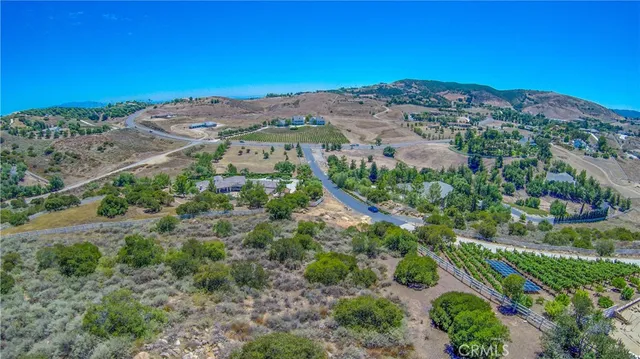 an aerial view of a residential houses and mountain view in back