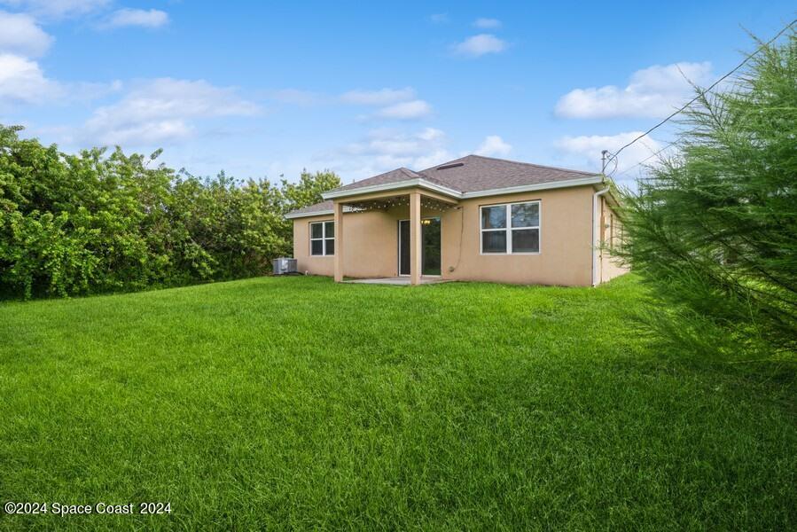 758 Fletcher Road Southeast Palm Bay, FL 32909 - Photo 34 of 35 31_758-Fletcher-Rd-SE_Rear-View_Web