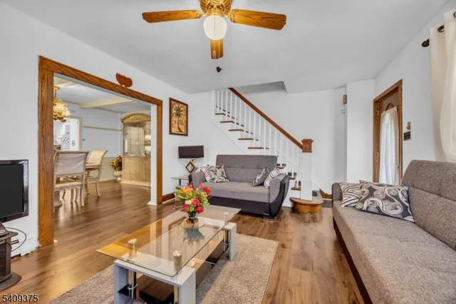 a living room with furniture and wooden floor
