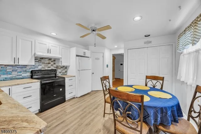 a kitchen that has a table and chairs in it
