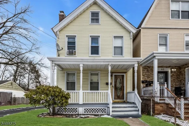 a front view of a house with garden and porch