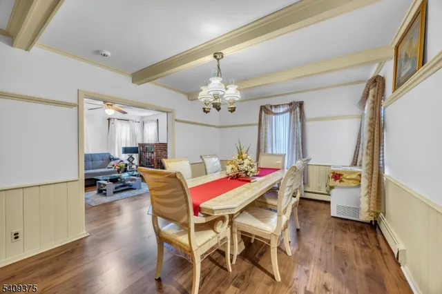 a view of a dining room with furniture and chandelier