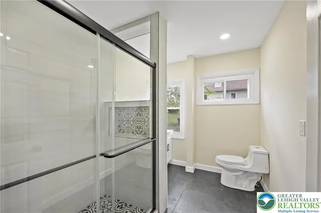 a bathroom with a toilet sink and a shower