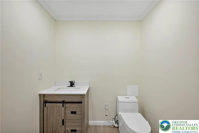 a bathroom with a sink a toilet and mirror