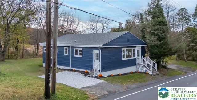 a view of house with a yard