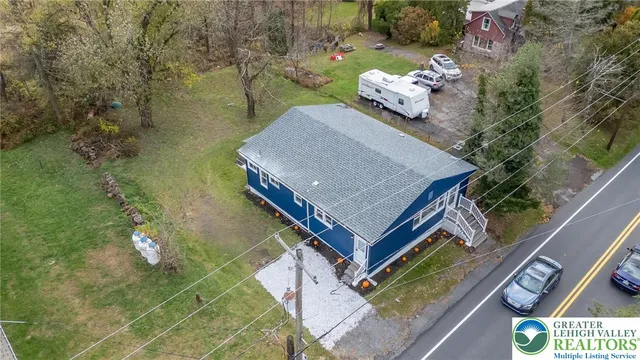 with aerial view of a house with a yard