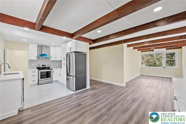 a kitchen with a refrigerator and a stove top oven