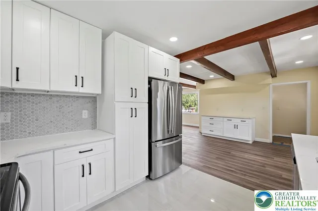 a kitchen with stainless steel appliances a refrigerator and cabinets