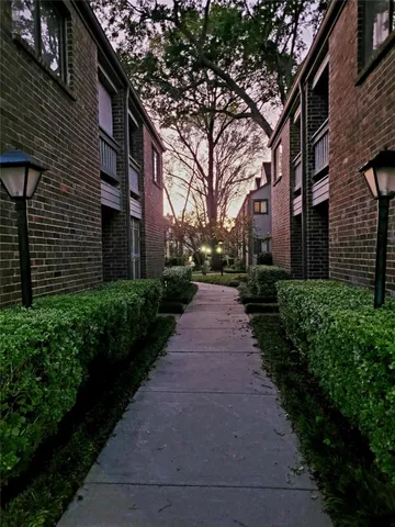 a view of a brick building next to a yard