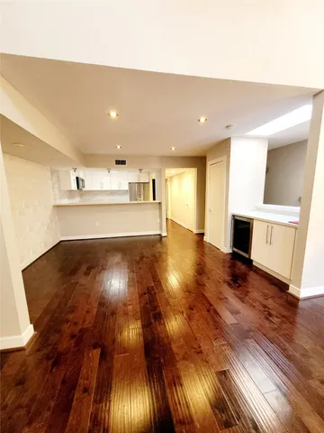 a view of an empty room and wooden floor