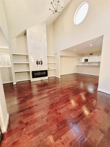 a view of empty room with wooden floor
