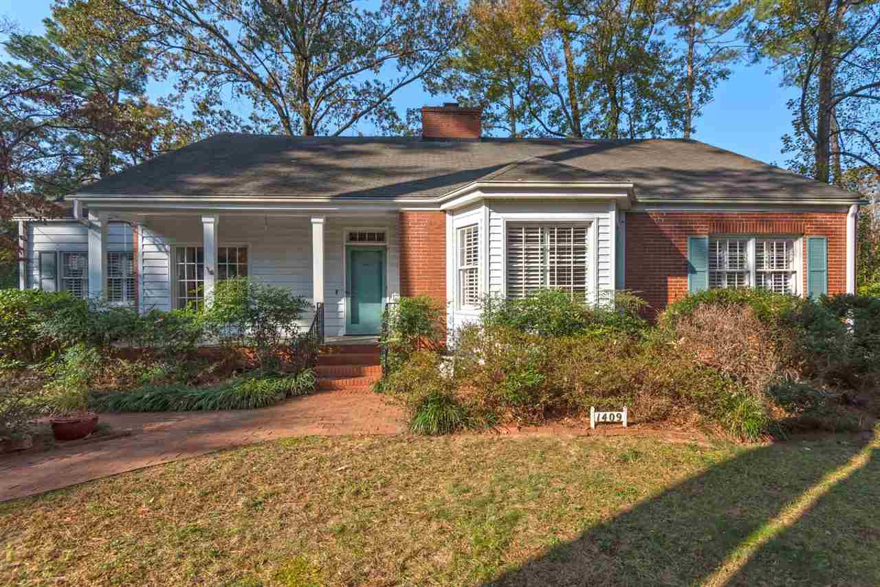 1409 Hathaway Road Raleigh, NC 27608 - Photo 1 of 25 a view of a house with brick walls and potted plants