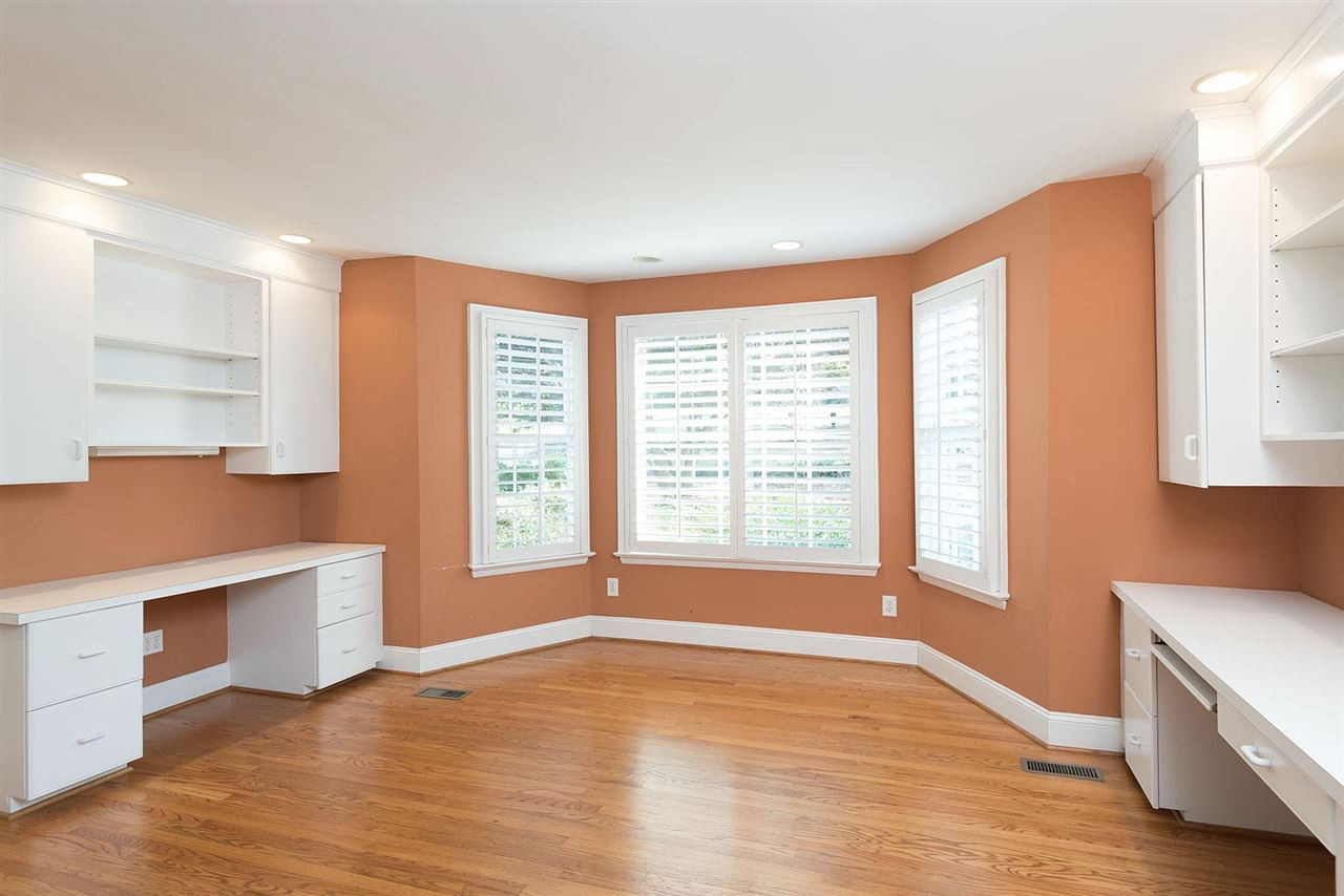 1409 Hathaway Road Raleigh, NC 27608 - Photo 11 of 25 a view of an empty room with a window and wooden floor