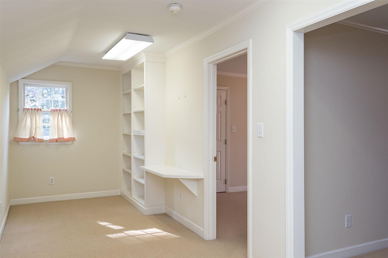 1409 Hathaway Road Raleigh, NC 27608 - Photo 14 of 25 a view of an empty room with closet and a window