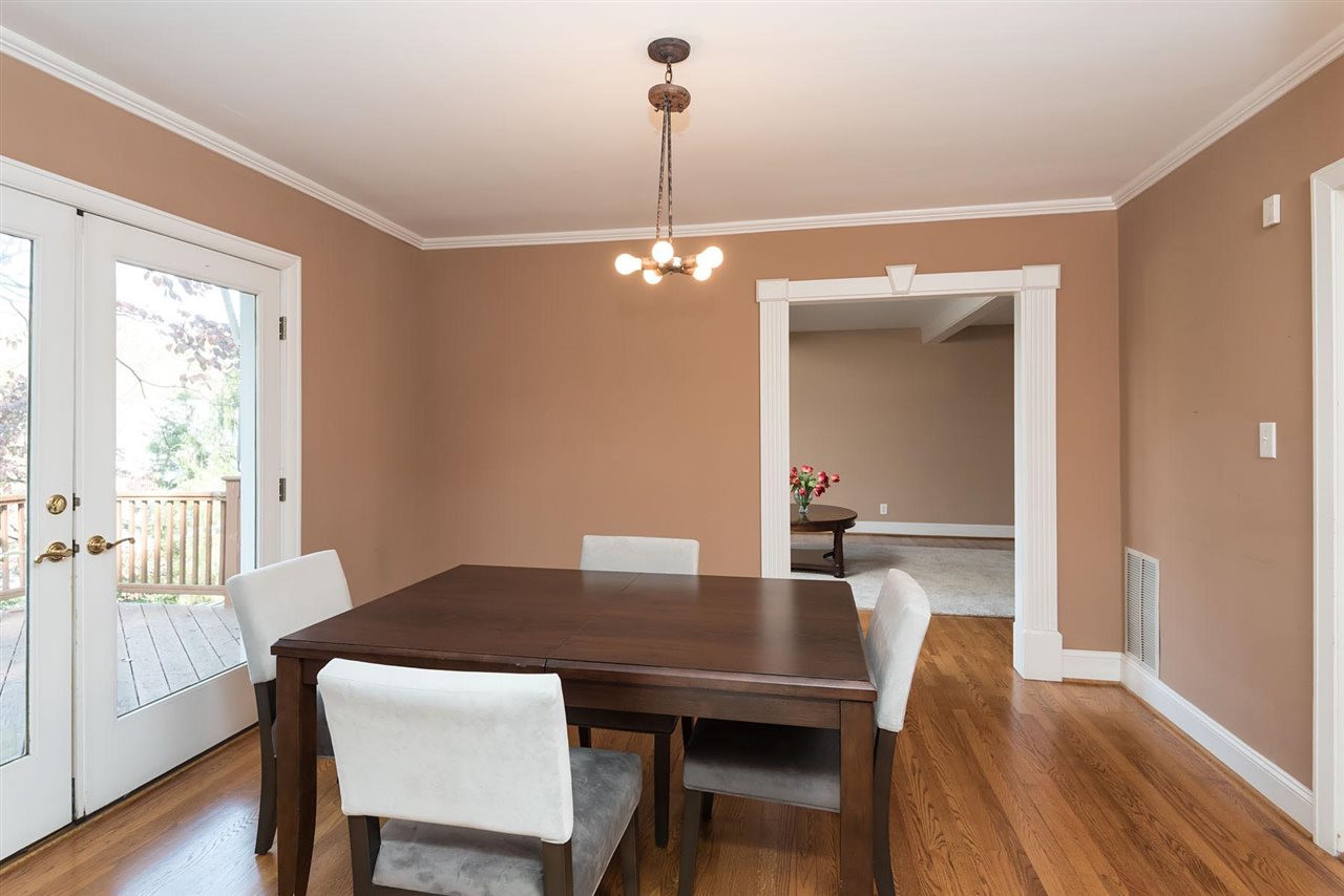 1409 Hathaway Road Raleigh, NC 27608 - Photo 6 of 25 a view of a dining room with furniture window and wooden floor