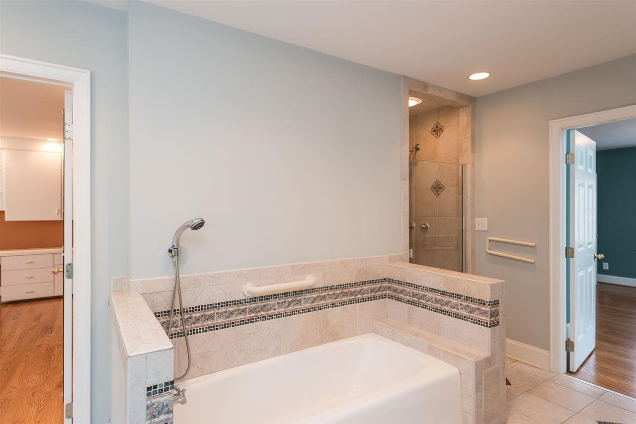 1409 Hathaway Road Raleigh, NC 27608 - Photo 10 of 25 a bathroom with a tub and shower