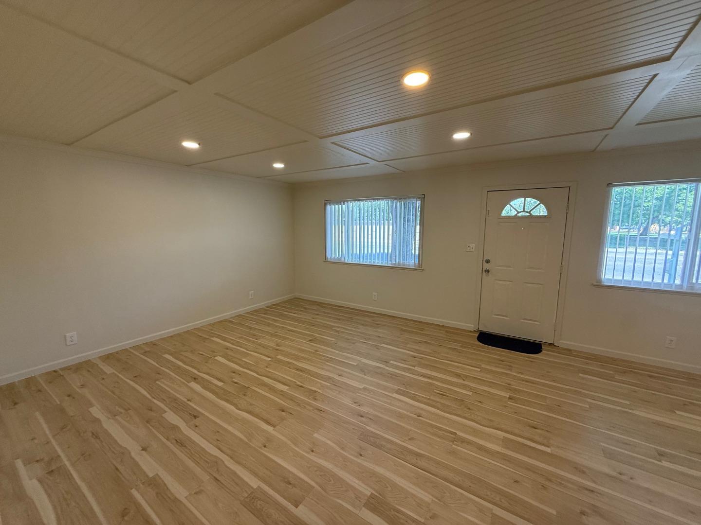 2505 Prescott Road, Unit 1 Modesto, CA 95350 - Photo 12 of 42 an empty room with wooden floor and windows