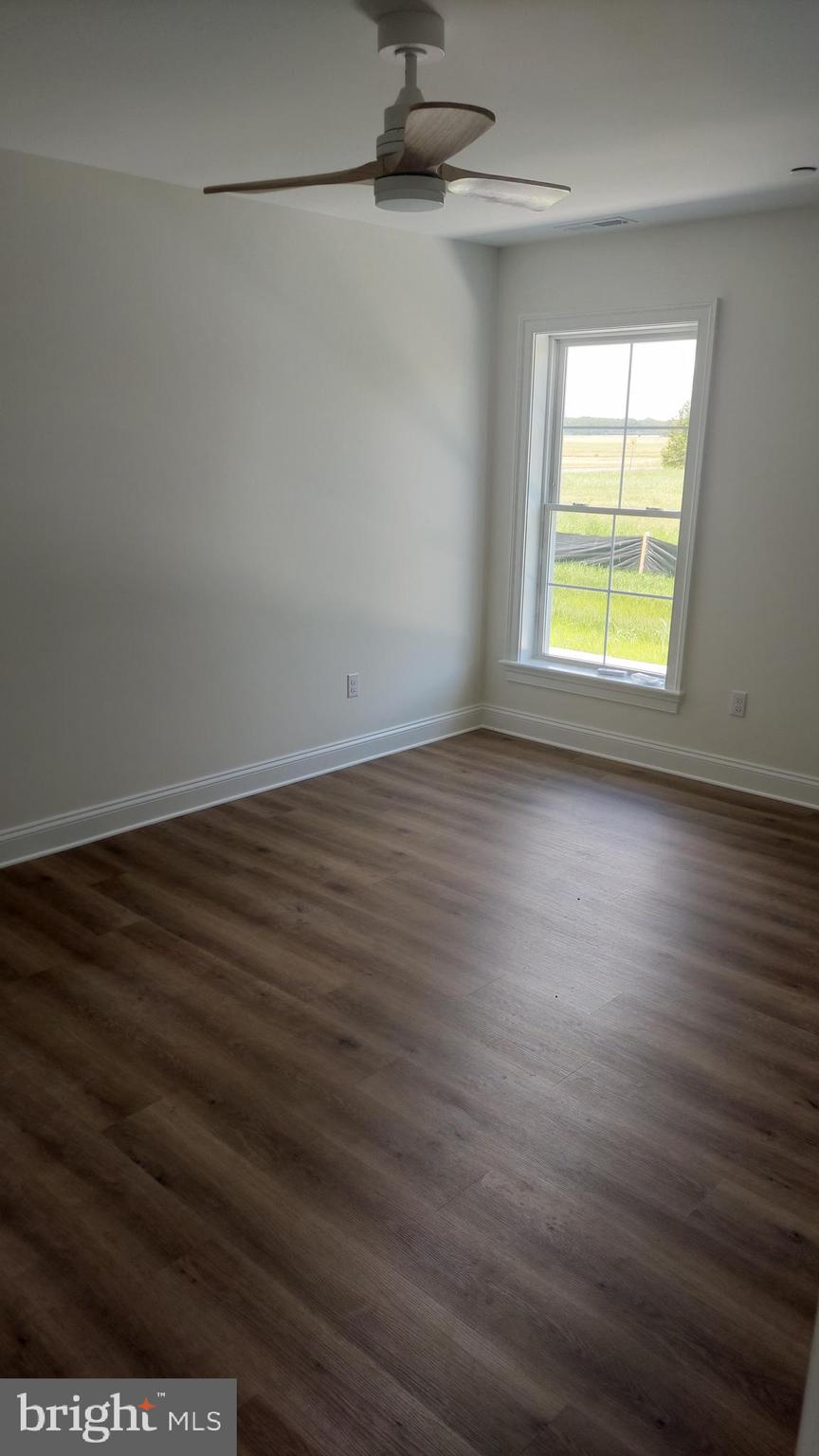 Michaels Way, Unit 1C East New Market, MD 21631 - Photo 4 of 12 a view of a room with wooden floor and a window