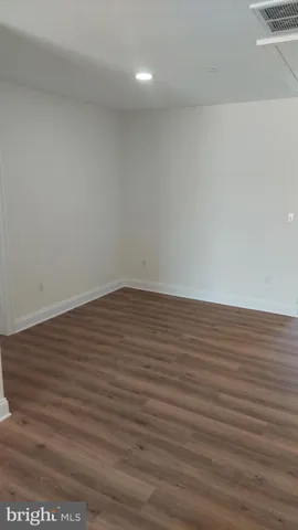 a view of room with wooden floor