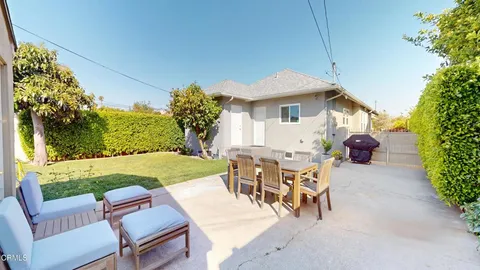 a view of a patio with table and chairs and potted plants