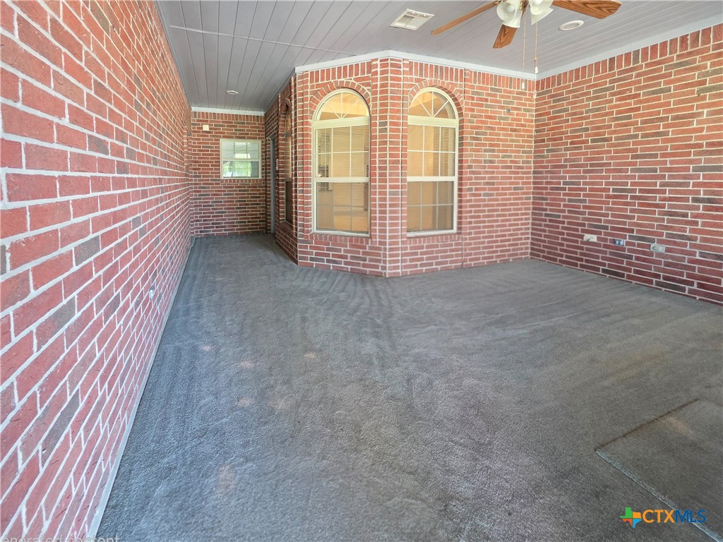 2450 West Amity Road Belton, TX 76513 - Photo 21 of 33 Comfy enclosed sunroom looking our to the back of the property.