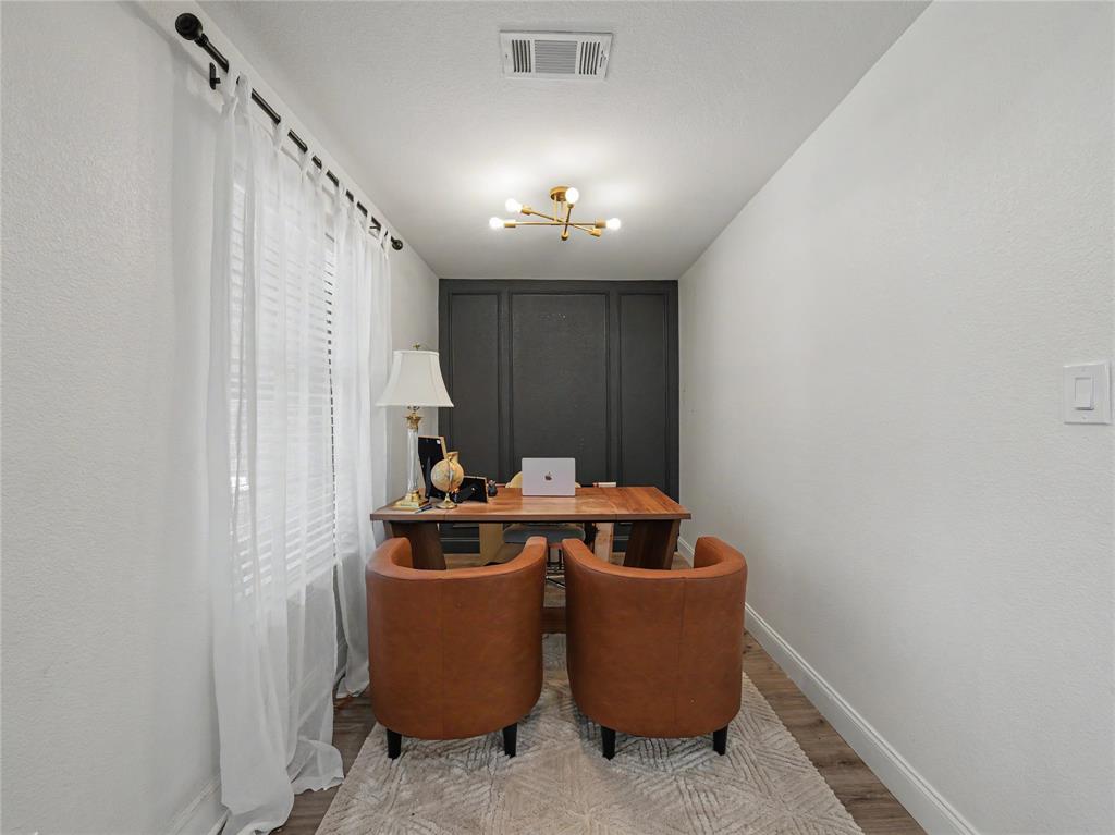 6701 Nauert Road Forest Hill, TX 76140 - Photo 14 of 40 Dedicated interior space featuring a dark paneled accent wall, wood-finish flooring, and crisp white baseboards