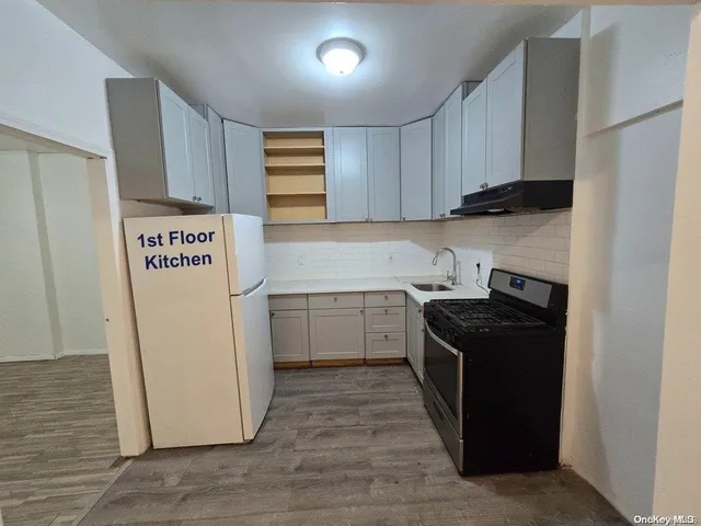 a kitchen with a stove top oven and cabinets