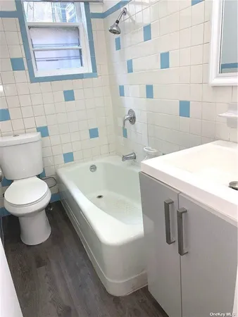 a bathroom with a bathtub and a toilet