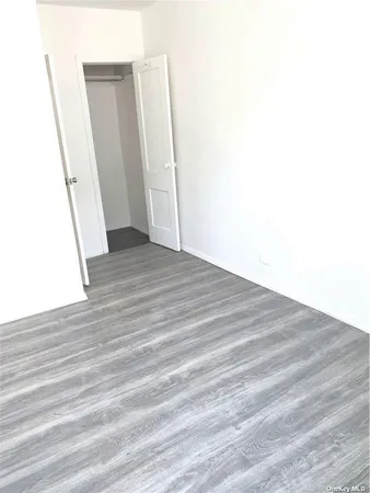 an empty room with wooden floor