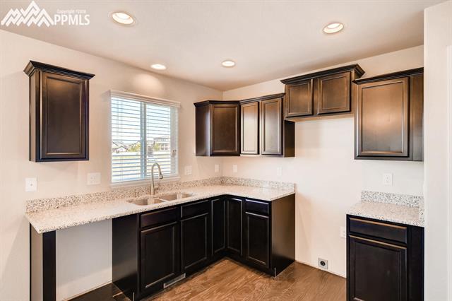 6118 Jorie Road Colorado Springs, CO 80927 - Photo 5 of 11 Granite countertops undercounted sink with Brushed Nickel faucet pull out sprayer.