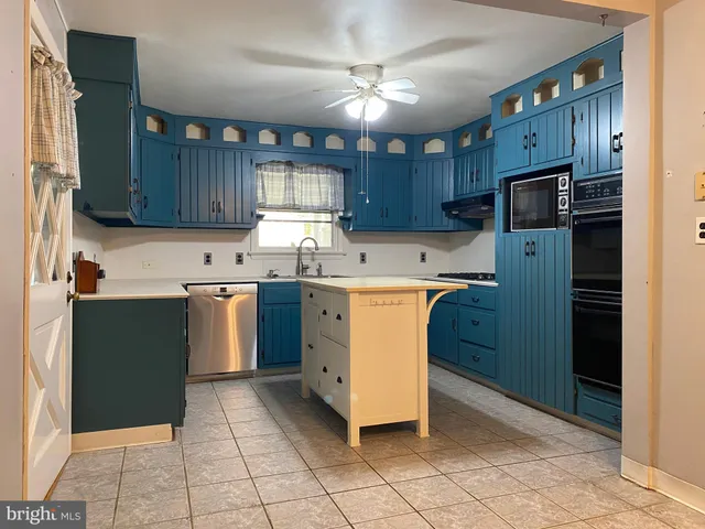 a kitchen with wooden cabinets and a stove top oven