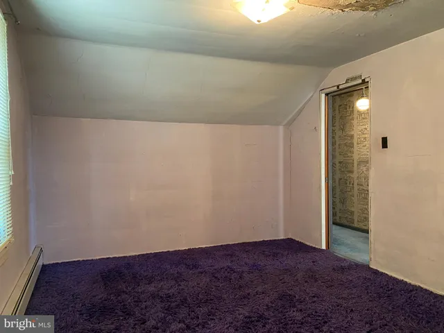 a room with a bench and windows