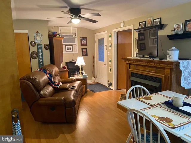 a work room with furniture a flat screen tv and a chandelier