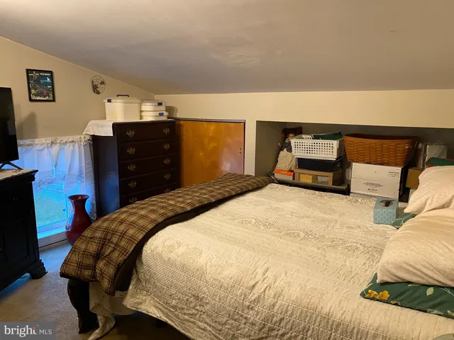 a bedroom with a bed and a dresser