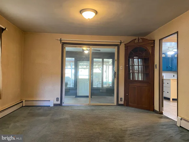 an entryway with a door and wooden floor