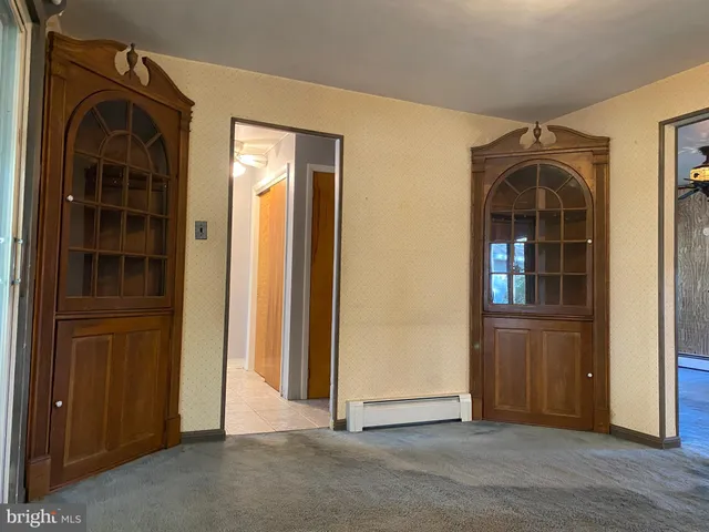 an empty room with closet and windows
