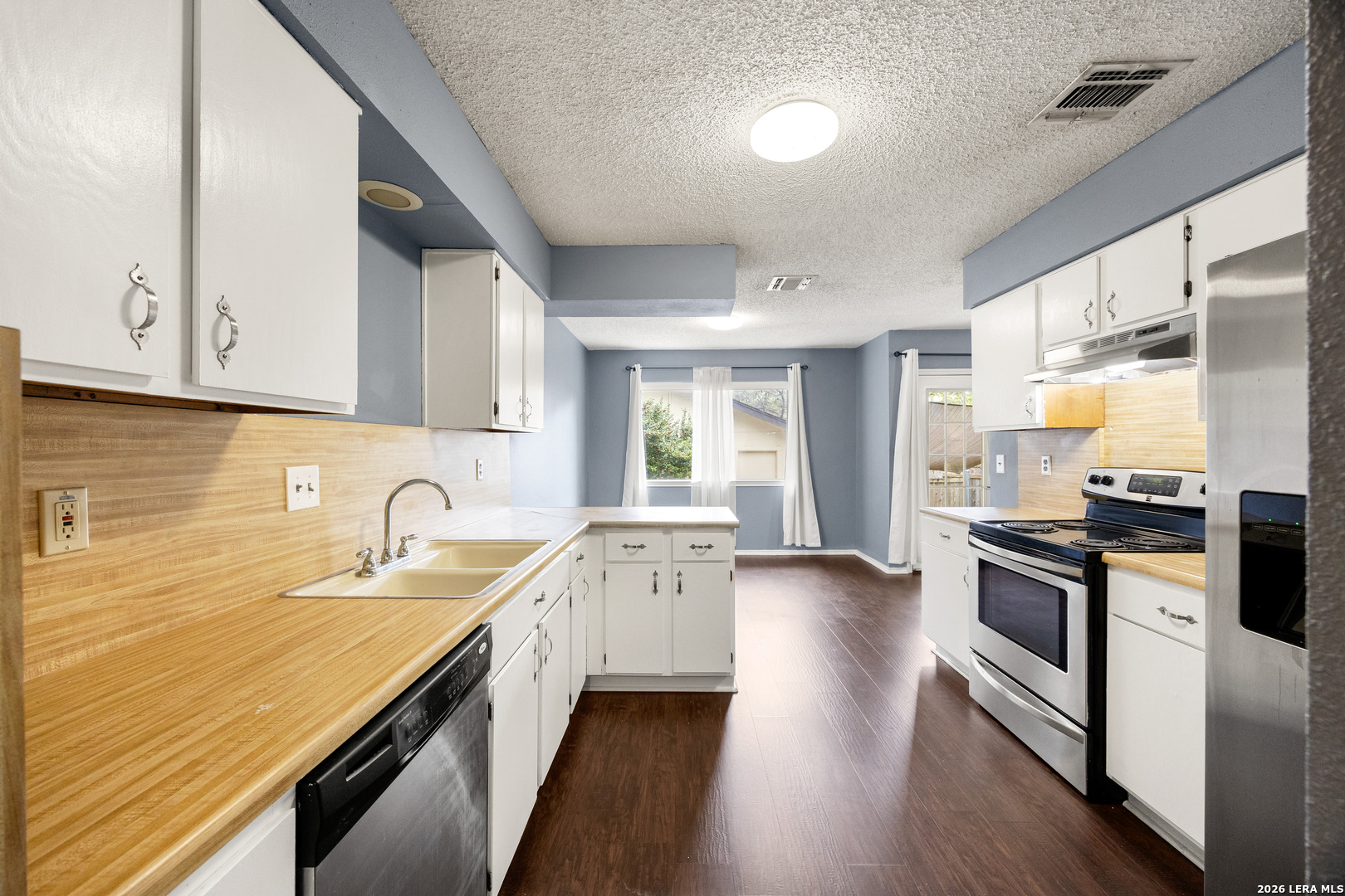 9334 Dover Ridge San Antonio, TX 78250 - Photo 16 of 42 a kitchen with a sink stove top oven and refrigerator