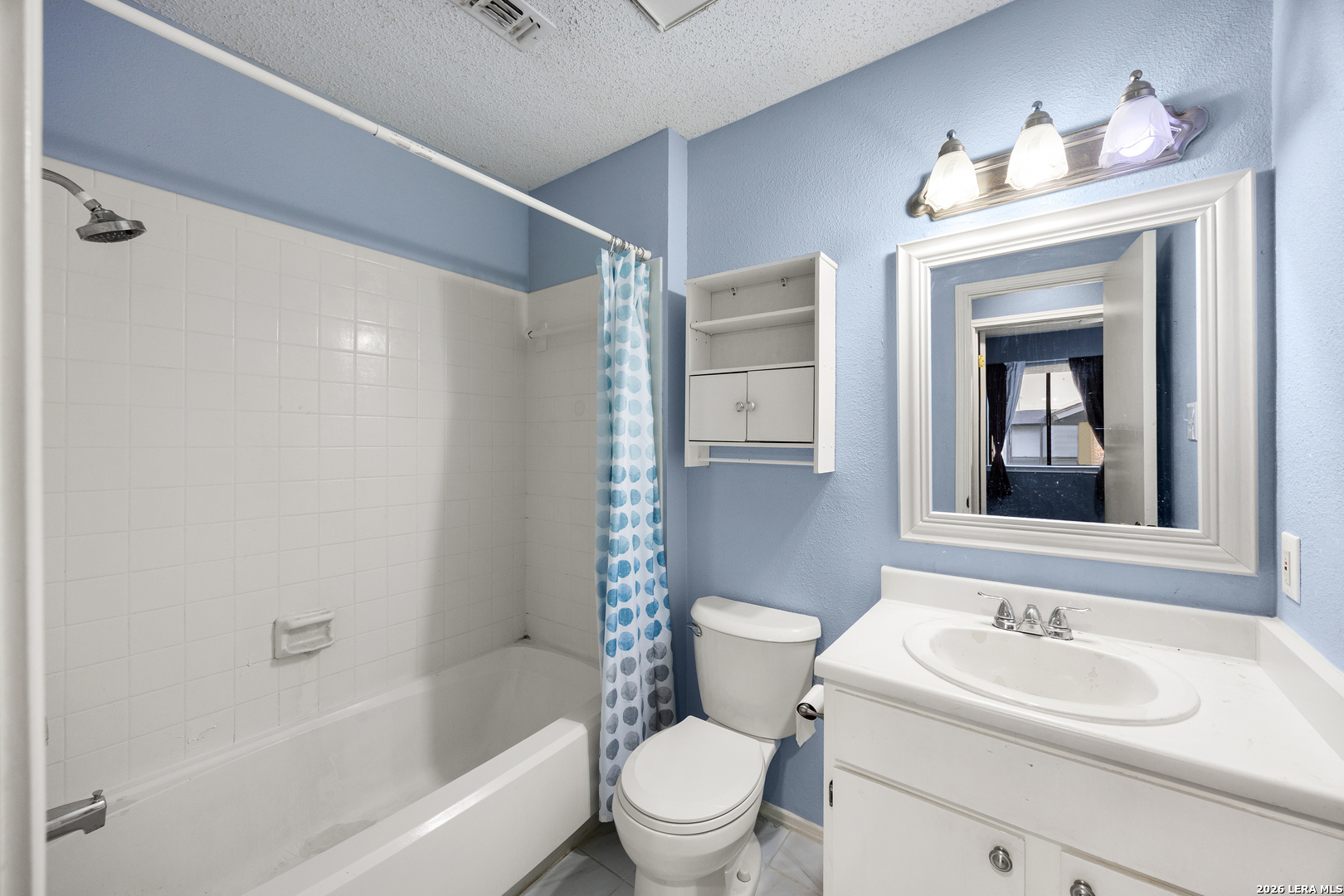 9334 Dover Ridge San Antonio, TX 78250 - Photo 20 of 42 a bathroom with a sink toilet vanity and shower