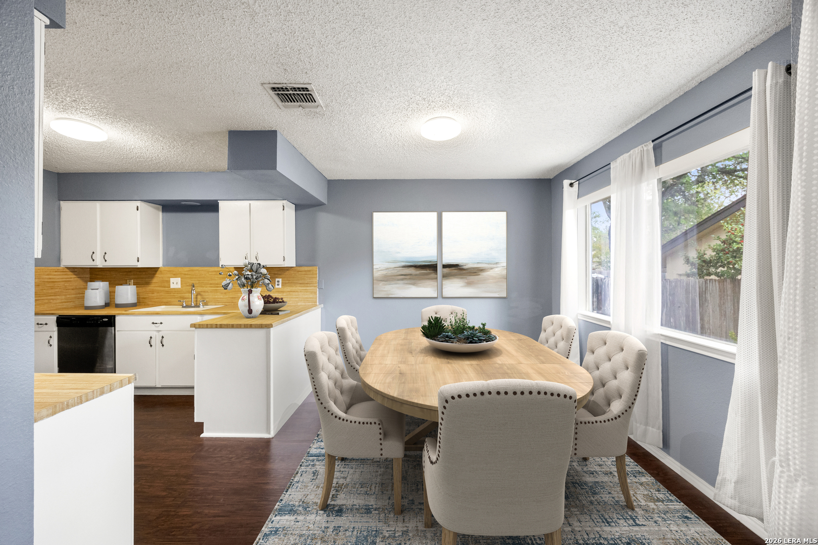 9334 Dover Ridge San Antonio, TX 78250 - Photo 6 of 42 a kitchen with a table chairs and microwave