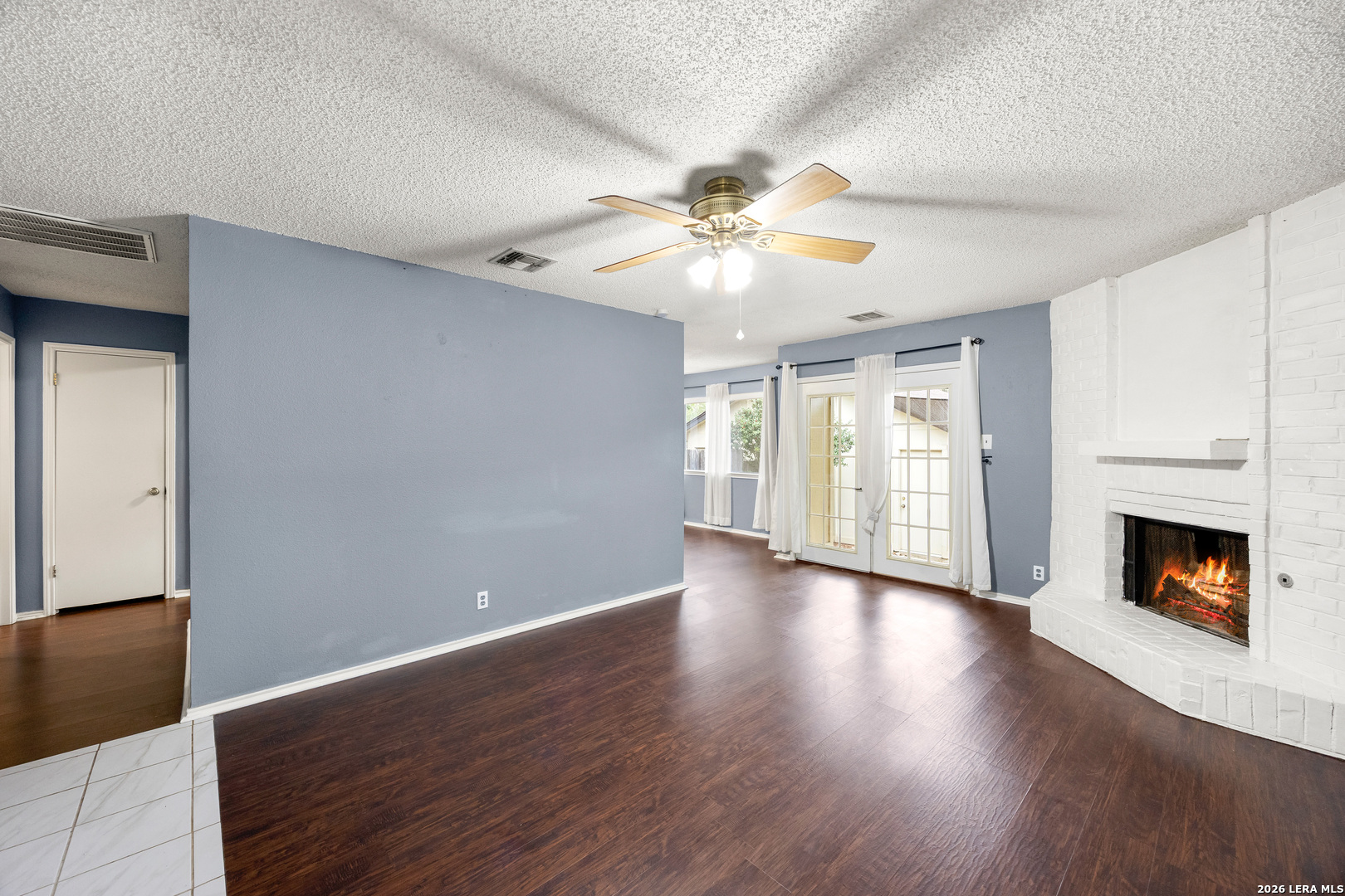 9334 Dover Ridge San Antonio, TX 78250 - Photo 9 of 42 a view of an empty room with window and wooden floor