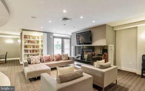 a living room with furniture pool table and a large window