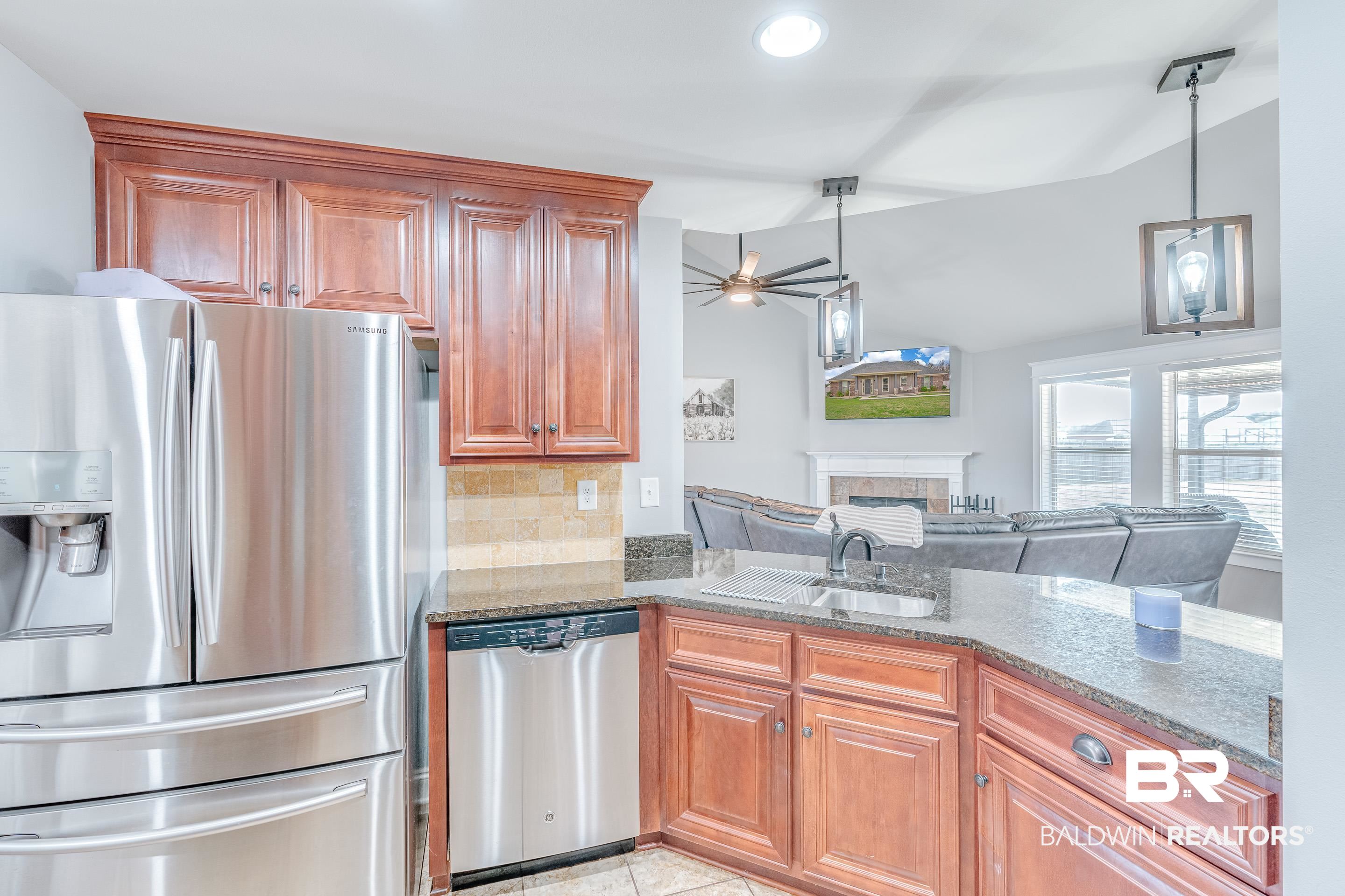 13235 Tom Gaston Road Mobile, AL 36695 - Photo 11 of 43 Kitchen featuring sink, decorative light fixtures, stainless steel appliances, and stone counters