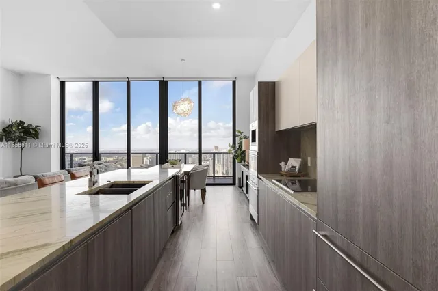 a living room with furniture and view of kitchen