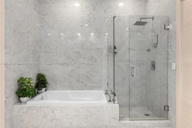 a bathroom with a bathtub and a shower