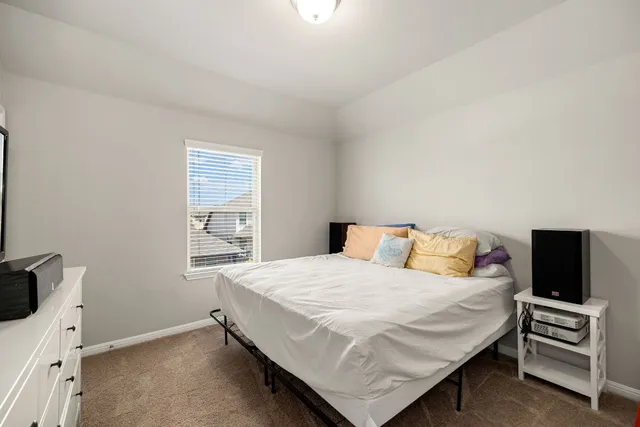 a bedroom with a bed and a tv